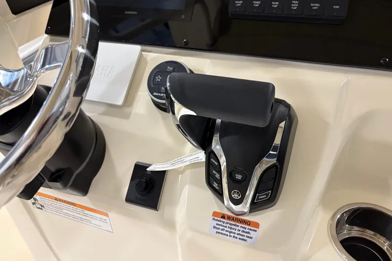 Slide: The Image of Control panel of 2025 Scout 215 XSF boat with steering wheel and throttle. - 8