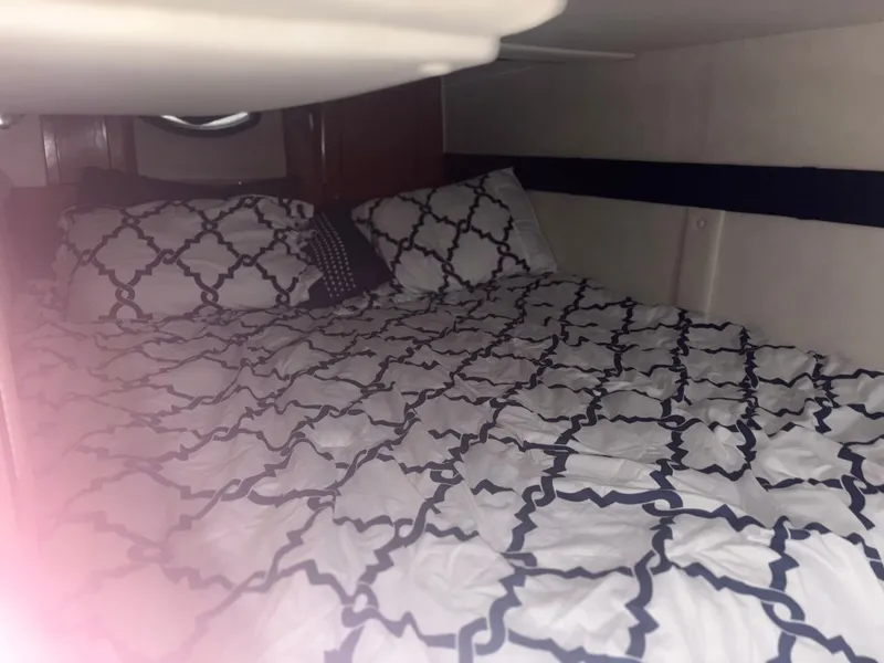 Slide: The Image of Interior of a 2001 Doral 330 SE with cozy bed. - 15