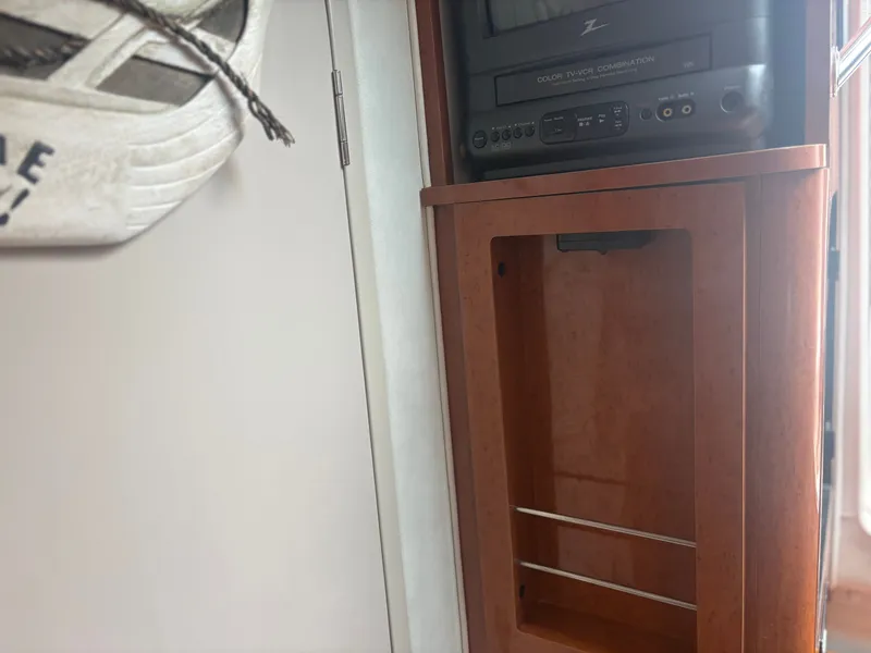 Slide: The Image of Interior of a Doral 330 SE boat with TV and wooden cabinet. - 18