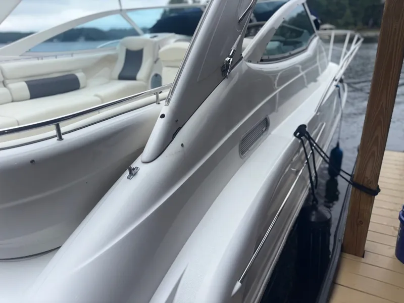 Slide: The Image of 2001 Doral 330 SE boat docked, showcasing luxurious design. - 6