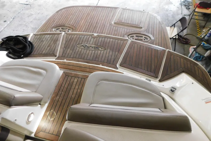 Slide: The Image of 2012 Sea Ray 300 SLX boat interior with wooden deck and cushioned seating. - 10