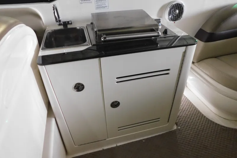 Slide: The Image of 2012 Sea Ray 300 SLX boat interior with sink and storage cabinet. - 16
