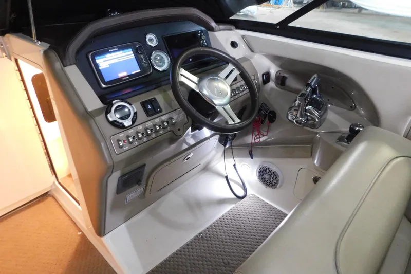 Slide: The Image of Interior cockpit of a 2012 Sea Ray 300 SLX boat with steering wheel and controls. - 21