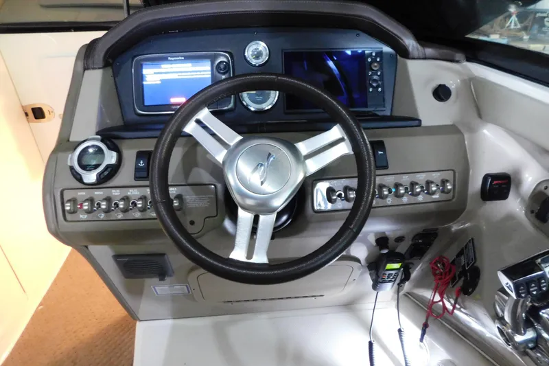 Slide: The Image of Dashboard of a 2012 Sea Ray 300 SLX boat with steering wheel and controls. - 23