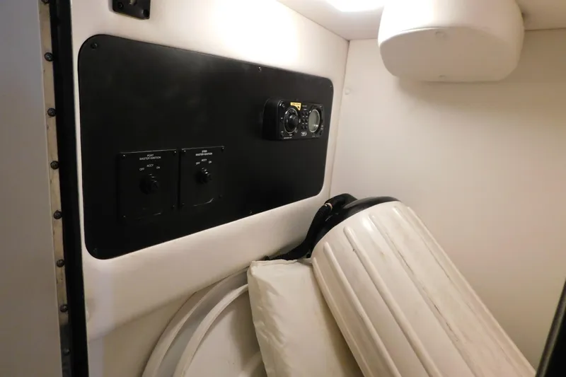 Slide: The Image of Interior of 2012 Sea Ray 300 SLX boat with control panel and storage area. - 26