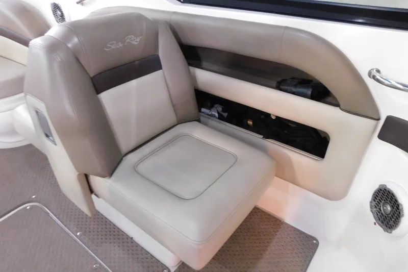 Slide: The Image of 2012 Sea Ray 300 SLX boat interior with beige seating and storage compartment. - 27