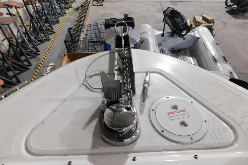 Slide: The Image of 2012 Sea Ray 300 SLX boat deck with anchor chain and winch in a storage area. - 31