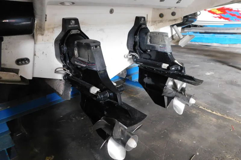 Slide: The Image of Twin MerCruiser outdrives on a 2012 Sea Ray 300 SLX boat in a garage. - 49