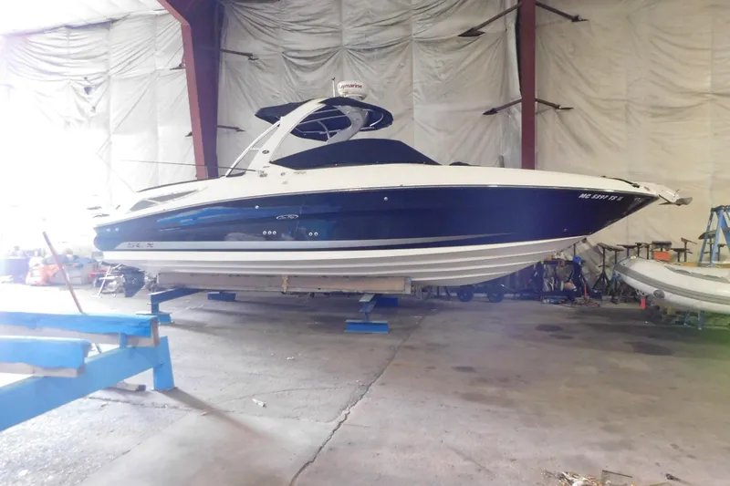 The Image of 2012 Sea Ray 300 SLX boat in indoor storage facility. - 8