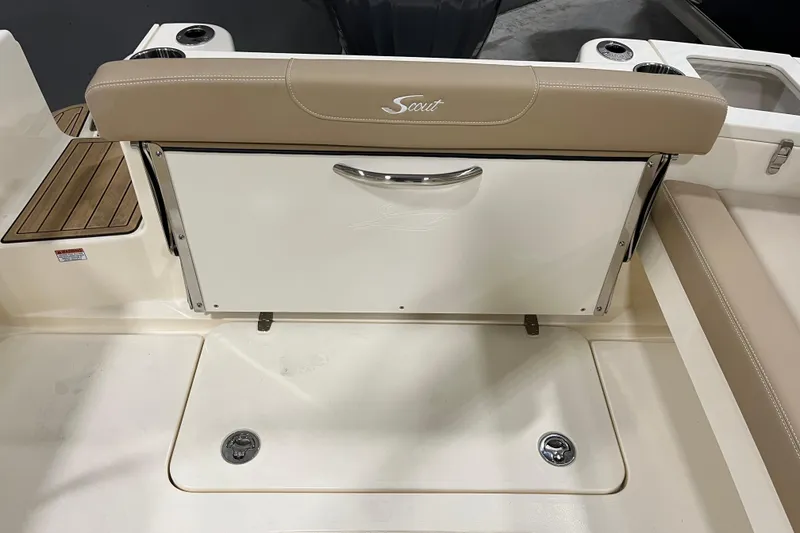 Slide: The Image of 2025 Scout 215 Dorado boat interior with beige seating and storage compartment. - 11