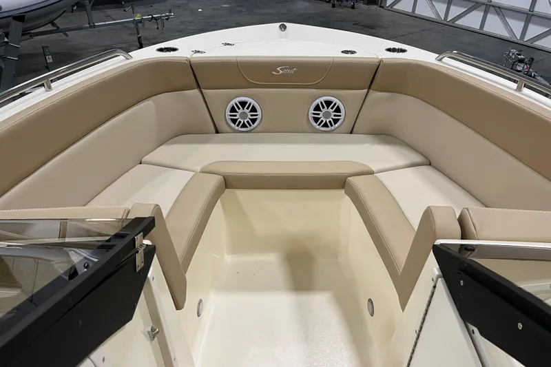 Slide: The Image of 2025 Scout 215 Dorado boat interior with beige seating and built-in speakers. - 14