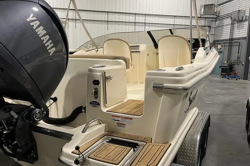 Slide: The Image of 2025 Scout 215 Dorado boat with Yamaha engine in a garage setting. - 5
