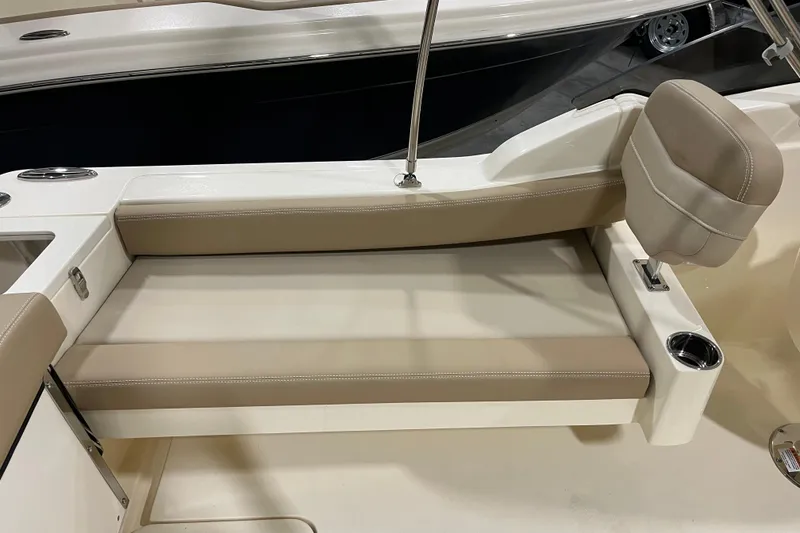Slide: The Image of 2025 Scout 215 Dorado boat interior with beige seating and cup holder. - 7