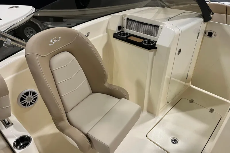 Slide: The Image of 2025 Scout 215 Dorado boat interior with beige seating and console features. - 8