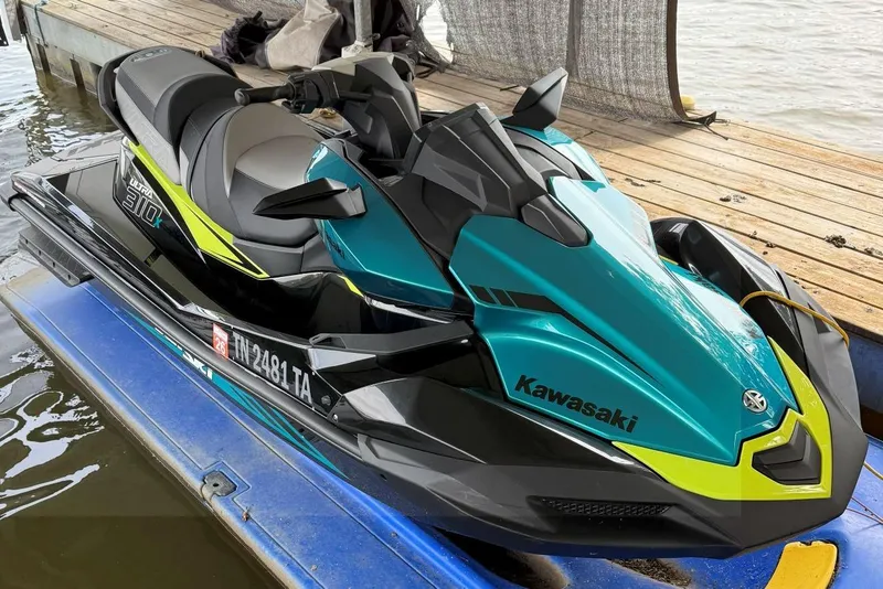 The Image of 2023 Kawasaki Jetski Ultra 310X on dock, vibrant teal and black design. - 1