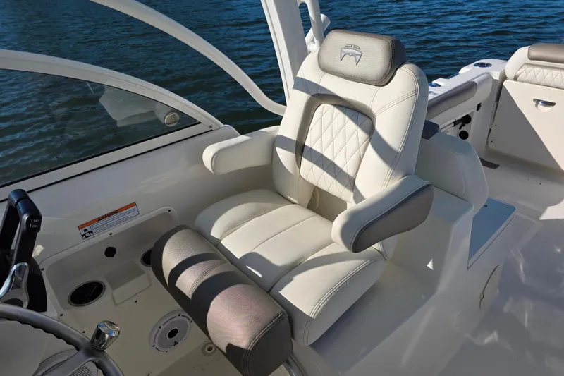 Slide: The Image of 2022 World Cat 255 DC boat interior with luxurious seating and helm. - 10