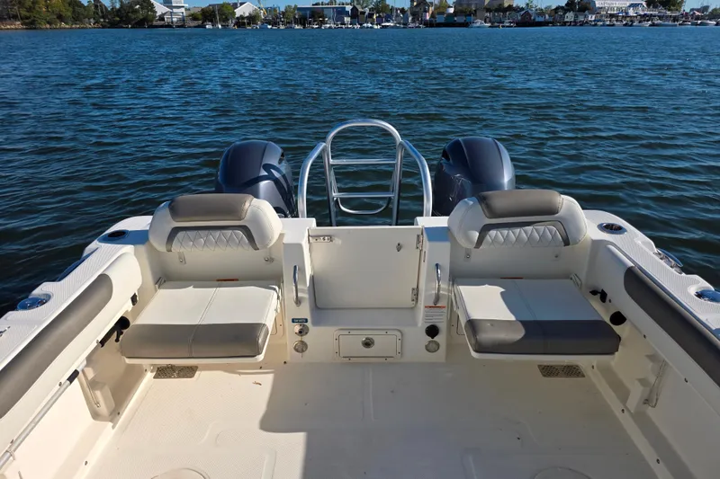 Slide: The Image of 2022 World Cat 255 DC boat interior with seating, on calm water. - 17