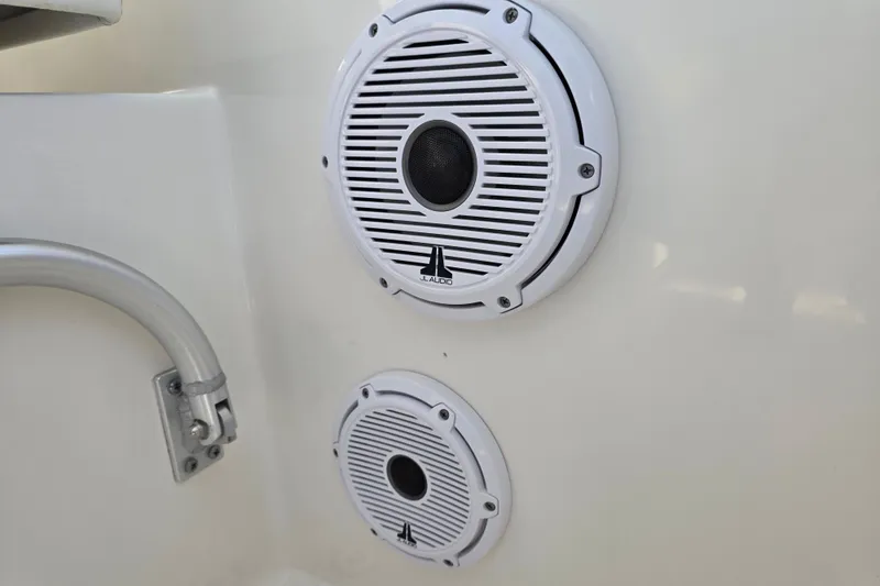 Slide: The Image of White JL Audio speakers on a 2022 World Cat 255 DC boat. - 21