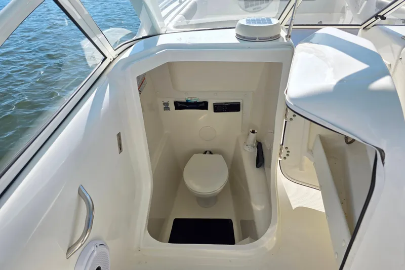 Slide: The Image of 2022 World Cat 255 DC boat interior with compact marine toilet. - 22