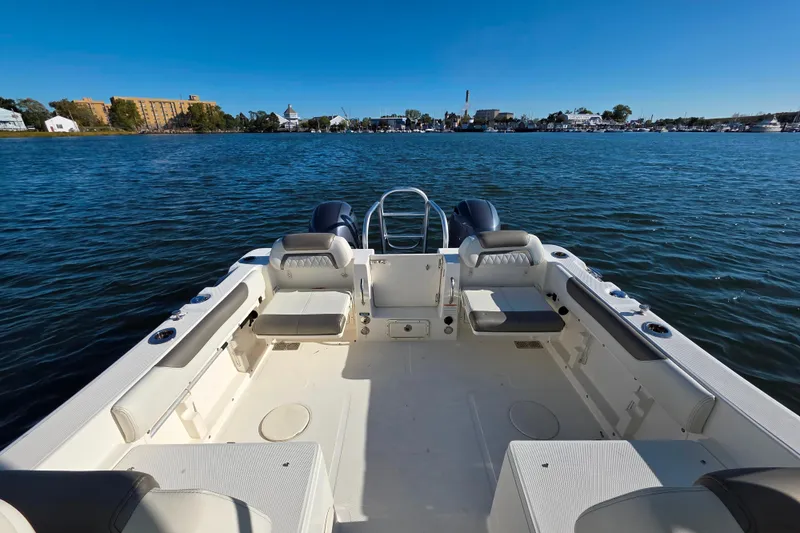 Slide: The Image of 2022 World Cat 255 DC boat interior with seating, overlooking calm waters and distant shoreline. - 5