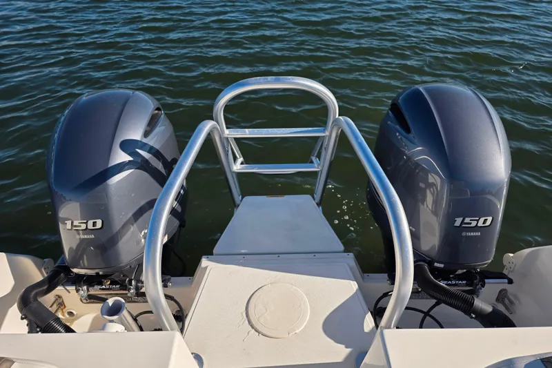 Slide: The Image of 2022 World Cat 255 DC boat with dual Yamaha 150 outboard engines on water. - 7