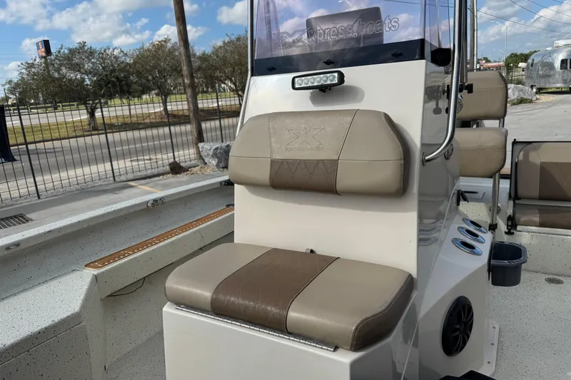 Slide: The Image of 2020 Xpress H20B Bay boat interior with cushioned seating and console. - 11