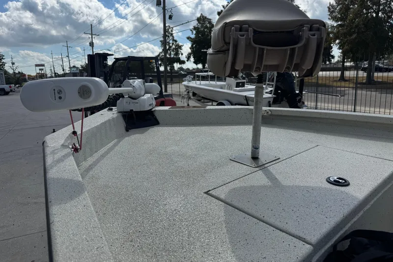 Slide: The Image of 2020 Xpress H20B Bay boat deck with seat and trolling motor under cloudy sky. - 14