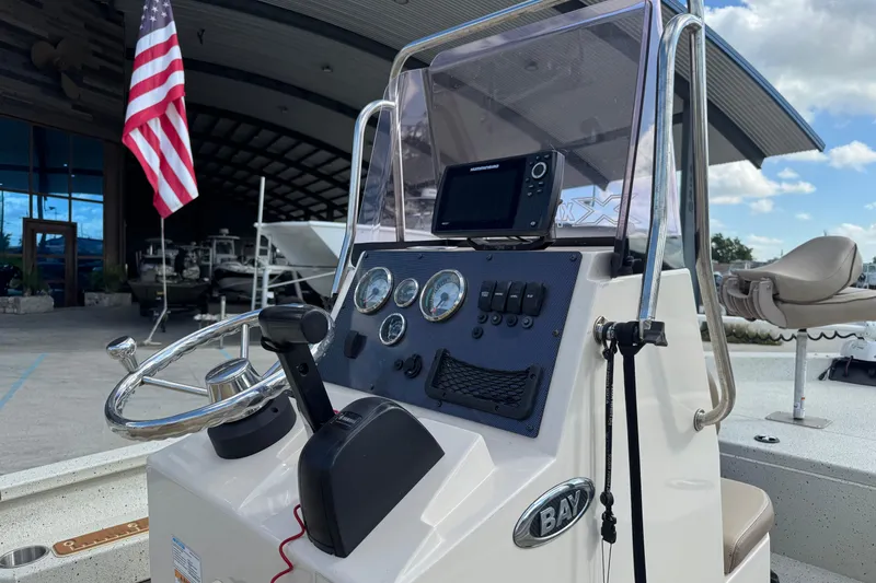 Slide: The Image of 2020 Xpress H20B Bay boat console with steering wheel and navigation system. - 16