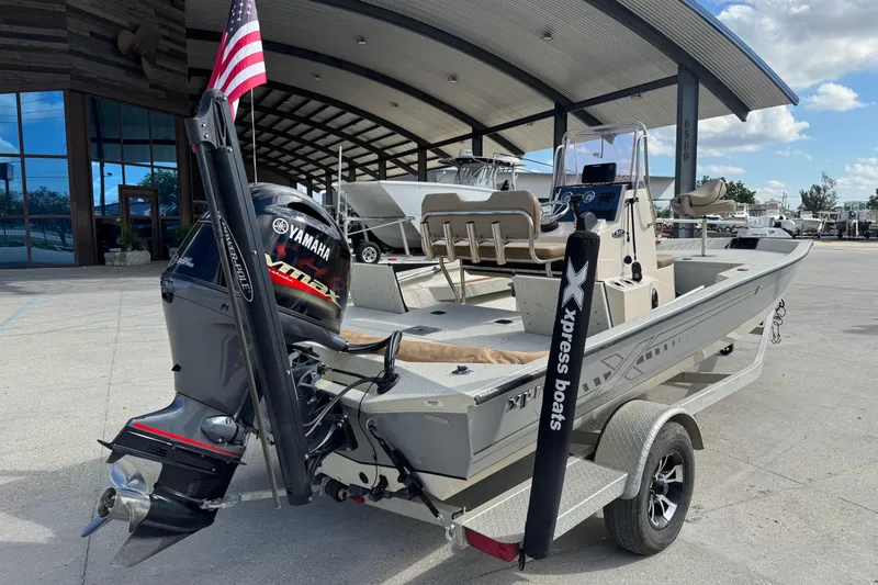 Slide: The Image of 2020 Xpress H20B Bay boat with Yamaha engine, displayed outdoors under a canopy. - 3