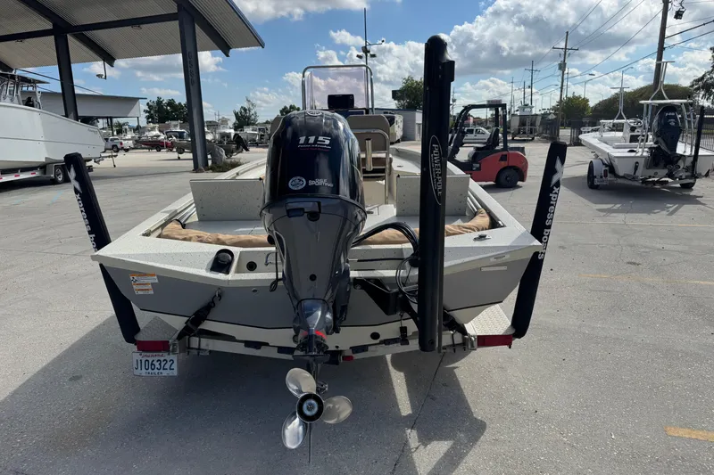 Slide: The Image of 2020 Xpress H20B Bay boat with 115 HP engine at a marina. - 4