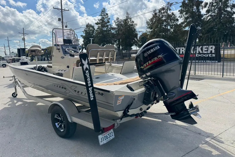 Slide: The Image of 2020 Xpress H20B Bay boat with Yamaha engine on trailer, parked outdoors. - 5