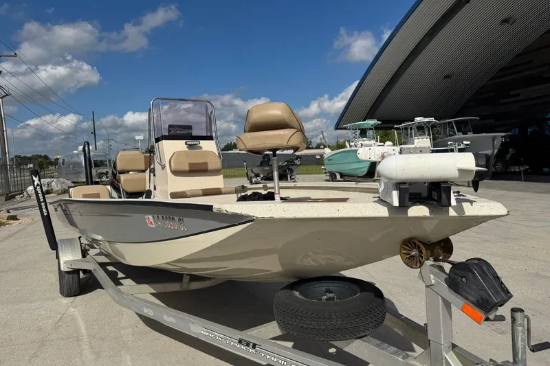 Slide: The Image of 2020 Xpress H20B Bay boat on trailer, parked outdoors under blue sky. - 8
