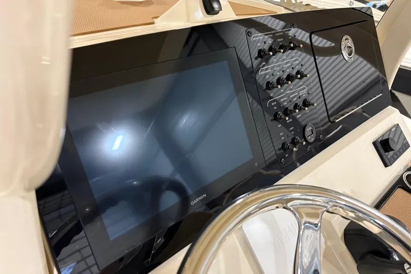 Slide: The Image of 2025 Scout 240 XSF boat dashboard with touchscreen and control panel. - 10