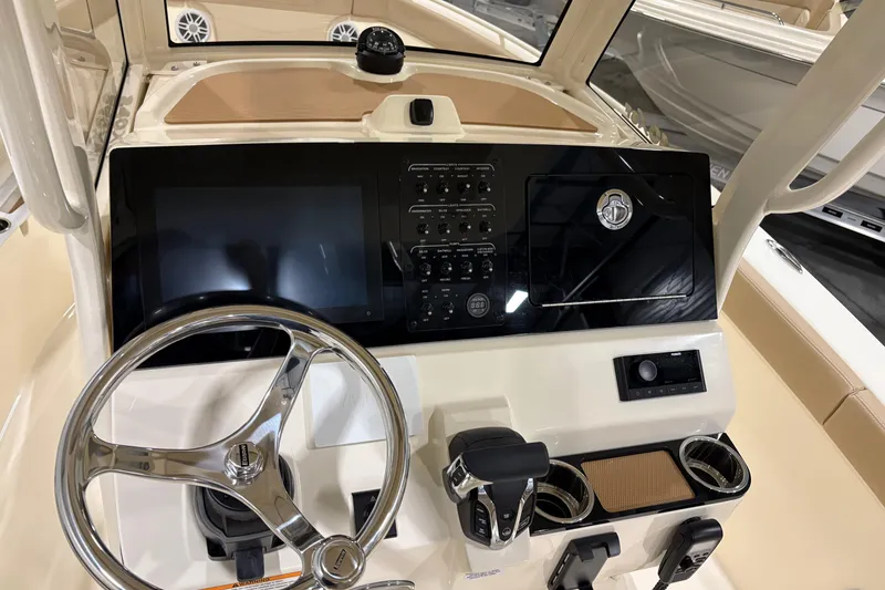 Slide: The Image of 2025 Scout 240 XSF boat dashboard with steering wheel, controls, and display screen. - 8