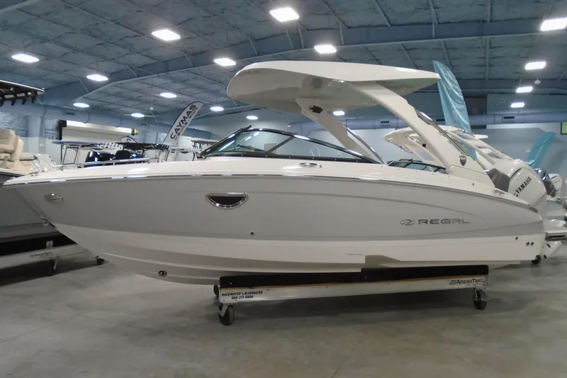 The Image of 2026 Regal LX4 boat displayed indoors, showcasing sleek design and modern features. - 0