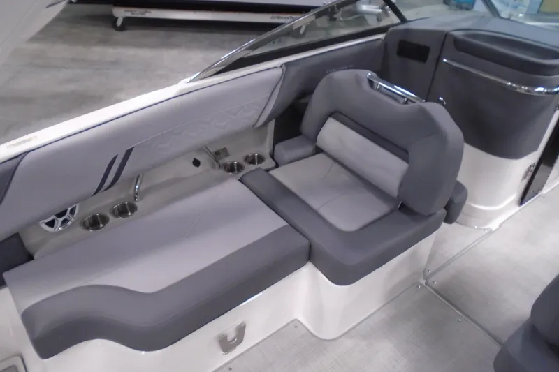 Slide: The Image of 2026 Regal LX4 boat interior with gray seating and cup holders. - 11