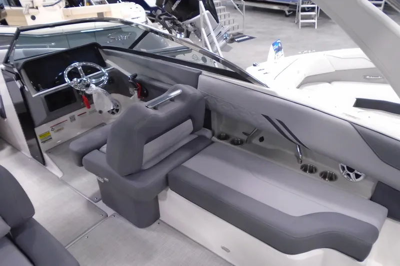 Slide: The Image of 2026 Regal LX4 boat interior with sleek gray seating and modern steering console. - 12