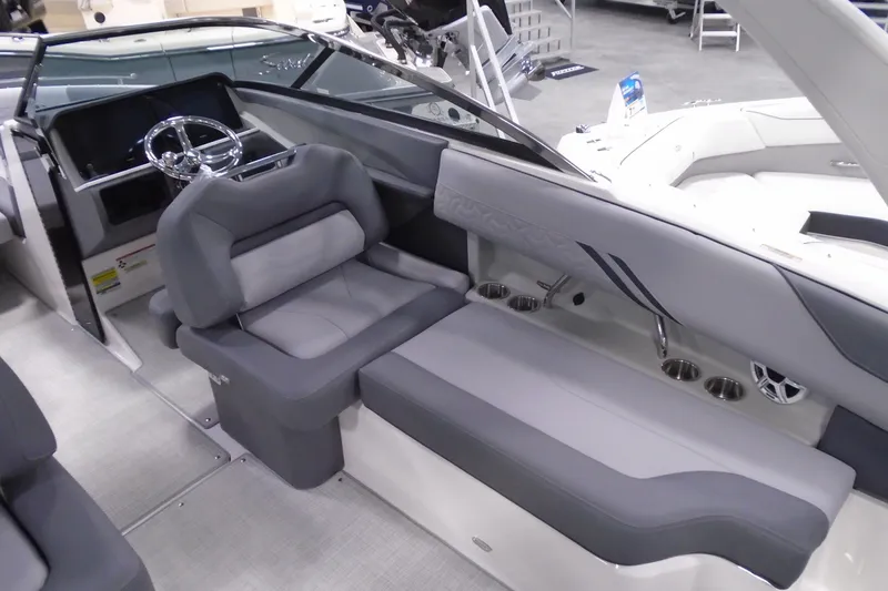Slide: The Image of 2026 Regal LX4 boat interior with sleek gray seating and modern steering wheel design. - 13