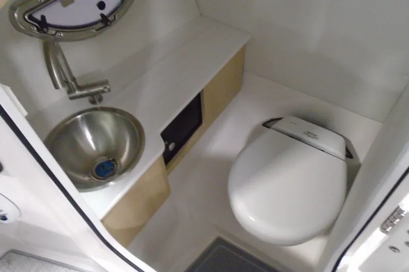 Slide: The Image of Compact bathroom in 2026 Regal LX4 boat with stainless steel sink and modern toilet. - 17