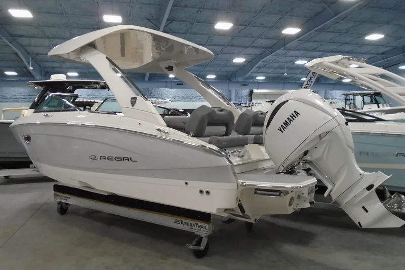 Slide: The Image of 2026 Regal LX4 boat with Yamaha engine displayed indoors. - 3