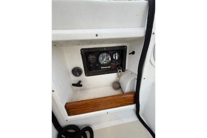 Slide: The Image of Control panel of a 1986 Tartan 37' sailboat with gauges and key. - 12