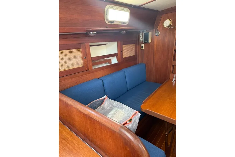 Slide: The Image of Interior of 1986 Tartan 37' sailboat with blue seating and wooden accents. - 16