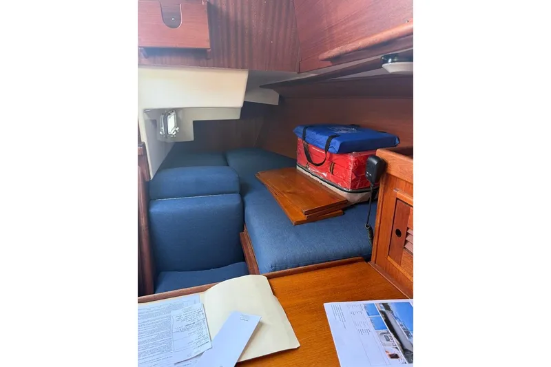 Slide: The Image of Interior of 1986 Tartan 37' sailboat with blue cushions and wooden accents. - 17