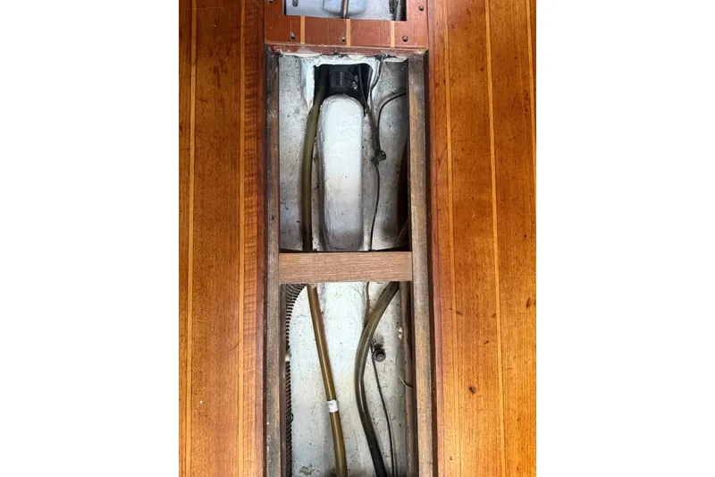 Slide: The Image of Wooden interior of 1986 Tartan 37' sailboat, showing exposed wiring and pipes. - 28