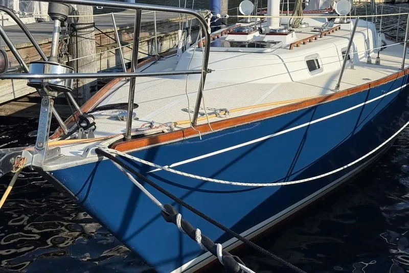 Slide: The Image of 1986 Tartan 37' sailboat with blue hull docked at marina. - 3