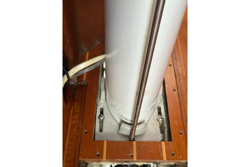 Slide: The Image of Mast base of 1986 Tartan 37' sailboat, featuring wooden deck and metal fittings. - 30
