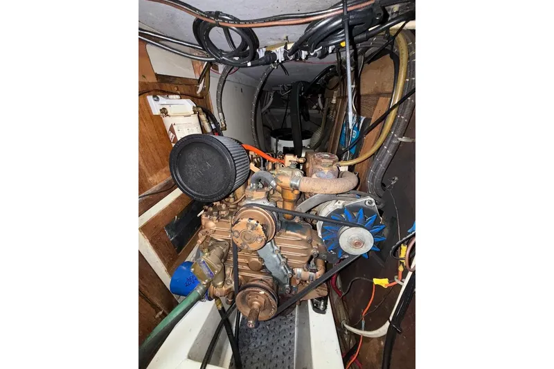 Slide: The Image of Engine compartment of a 1986 Tartan 37' sailboat, showcasing mechanical components. - 31