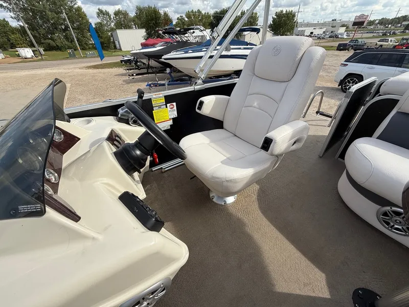 Slide: The Image of 2012 Premier 180 SunSation boat interior with captain's chair and steering console. - 12