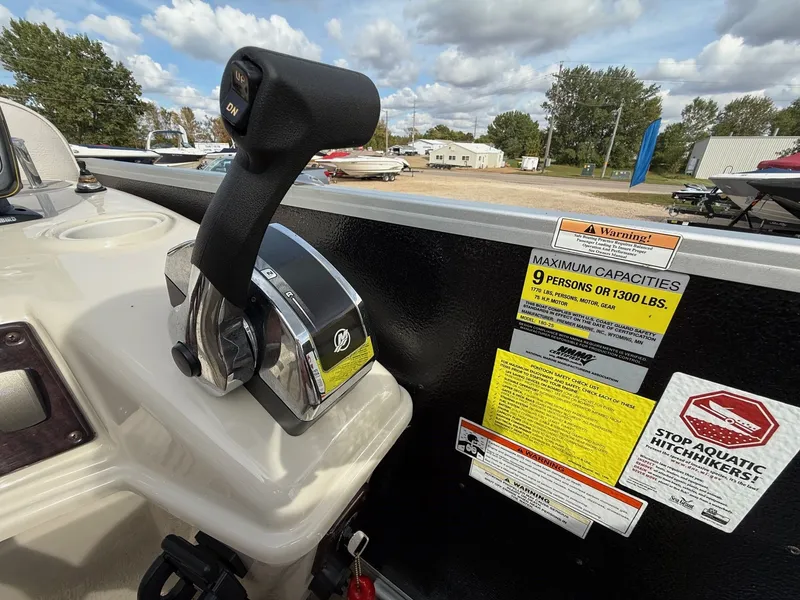 Slide: The Image of Control panel of a 2012 Premier 180 SunSation boat with capacity warnings. - 15