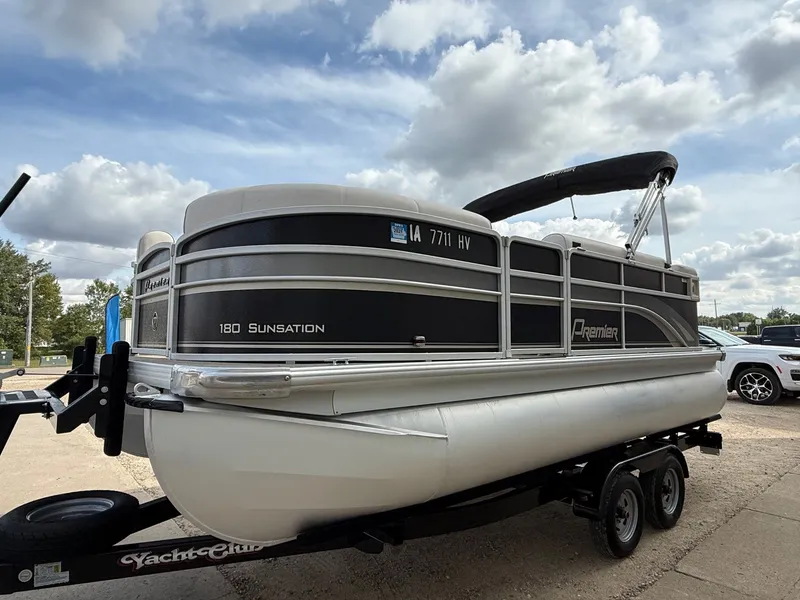 Slide: The Image of 2012 Premier 180 SunSation pontoon boat on trailer under cloudy sky. - 2